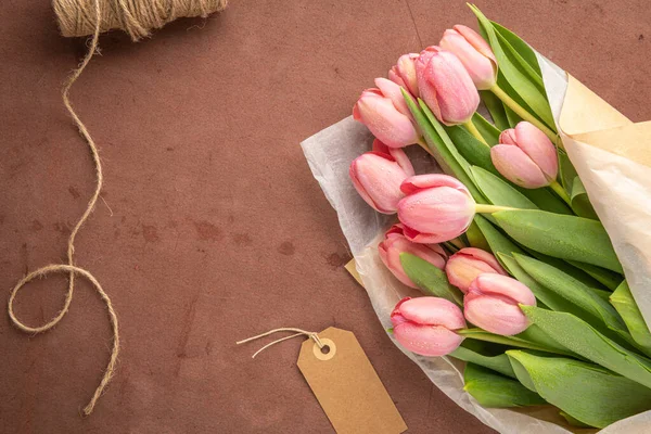 粉红郁金香花束在红色水泥背景上 平躺在地上 尽收眼底 春花概念 — 图库照片