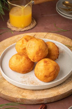 Rabanada 's poveiras with egg cream and cinnamon and pecan nuts on a rustic kitchen counter during the Christmas season.