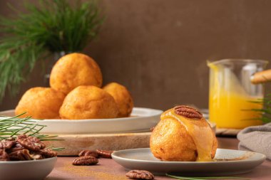 Rabanada 's poveiras with egg cream and cinnamon and pecan nuts on a rustic kitchen counter during the Christmas season.