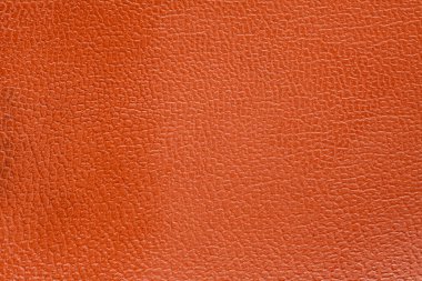 Lüks klasik arka plan olarak kullanılan turuncu deri dokular. Taklit, yapay deri dokusu arka planı. Soyut