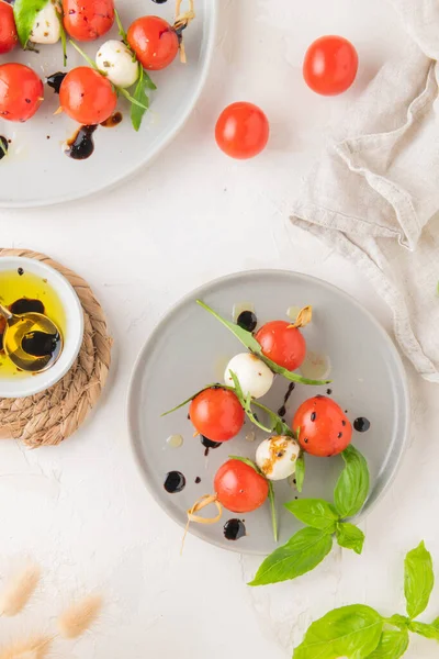 Caprese Skewers Tomatoes Mozzarella Balls Basil Spices White Table Closeup — Stock Photo, Image