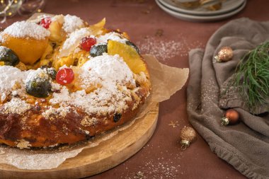 Bolo Rei or Kings Cake is a traditional Xmas cake with fruits raisins nut and icing on kitcthen countertop. Is made for Christmas, Carnavale or Mardi Gras