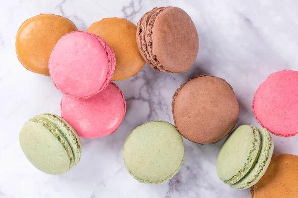 Stock image Colorful macaroons on marble background, top view vintage color style