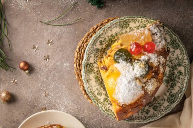 Bolo Rei or Kings Cake is a traditional Xmas cake with fruits raisins nut and icing on kitcthen countertop. Is made for Christmas, Carnavale or Mardi Gras