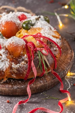 Bolo Rei or Kings Cake is a traditional Xmas cake with fruits raisins nut and icing on kitcthen countertop. Is made for Christmas, Carnavale or Mardi Gras
