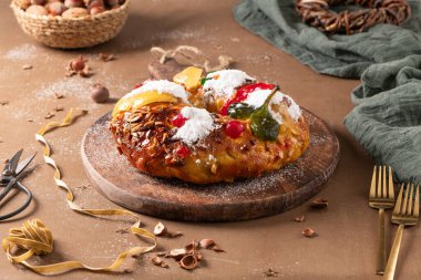 Bolo Rei or Kings Cake is a traditional Xmas cake with fruits raisins nut and icing on kitcthen countertop. Is made for Christmas, Carnavale or Mardi Gras