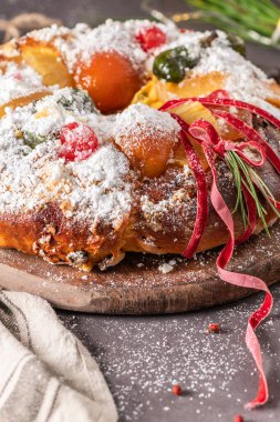 Bolo Rei or Kings Cake is a traditional Xmas cake with fruits raisins nut and icing on kitcthen countertop. Is made for Christmas, Carnavale or Mardi Gras