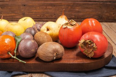 Wooden table full of fresh colorful fruits. Healthy eating and lifestyle. Healthy eating background with different fruits
