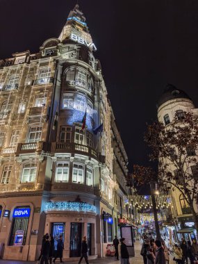 Porto, Portekiz - 6 Aralık 2023. Avenida dos Aliados 'ta yılbaşı ışıklarıyla süslenmiş Yapılandırıcı BBVA veya Yapılandırıcı Pinto Leite' in gece görüşü