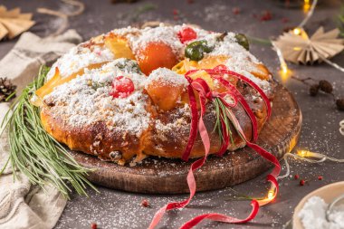 Bolo Rei or Kings Cake is a traditional Xmas cake with fruits raisins nut and icing on kitcthen countertop. Is made for Christmas, Carnavale or Mardi Gras