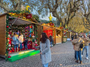 Santa Maria da Feira, Portugal - december 2 2023. Families shopping Christmas presents at traditional Xmas Perlim street market in Santa Maria da Feira, Portugal clipart