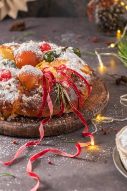 Bolo Rei or Kings Cake is a traditional Xmas cake with fruits raisins nut and icing on kitcthen countertop. Is made for Christmas, Carnavale or Mardi Gras