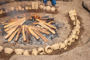 AMARANTE, PORTUGAL - CIRCA APRIL 2022: Preparation of the bonfire during the cooking process of the black clay of Gondar in Amarante, Portugal. clipart