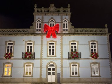 Sao Joao da Madeira, Portugal - december 1 2023. A walker s point of view of the old city streets decorated with Christmas lights. clipart