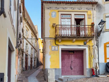 Old and narrow street in historical center of Coimbra, Portugal clipart