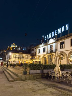 Gaia, Portekiz - 28 Kasım 2024: Gece gökyüzüne karşı aydınlanan ikonik Sandeman Mahzeni binası, Portekiz 'in zengin şarap üretim tarihinin bir kanıtı olan Vila Nova de Gaia' da gururla duruyor..
