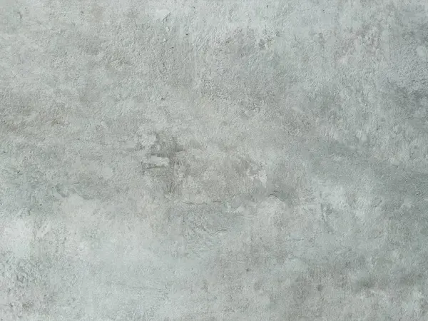 Eskimiş beton veya alçıya benzeyen, arka plan için mükemmel, ince varyasyonları ve işaretleri olan açık gri bir yüzeyin detaylı yakın plan görüntüleri.