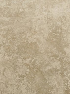 Eskimiş beton ya da alçıya benzeyen, arka plan için mükemmel, ince varyasyonları ve işaretleri olan, desenli, açık bej bir yüzeyin detaylı yakın çekimi.