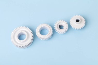 Beyaz dişliler fikir, işbirliği ya da takım çalışması, iş ve bağlantı kavramını sembolize ediyor