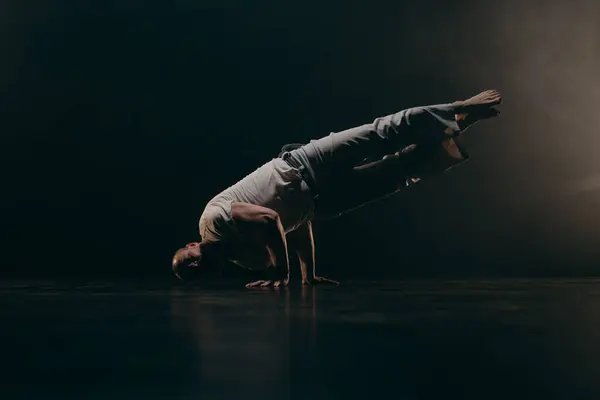 stock image Male fighter training capoeira on black background