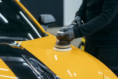 Atölyede sarı spor arabanın parlatılması süreci