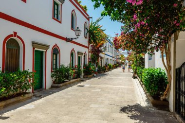 Puerto de Mogan, Gran Canaria, Spain. 18 July 2022: Narrow and flowery streets of Puerto de Mogan are eagerly visited by tourists