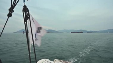 The Korean flag of the cruise ship swaying in the wind.