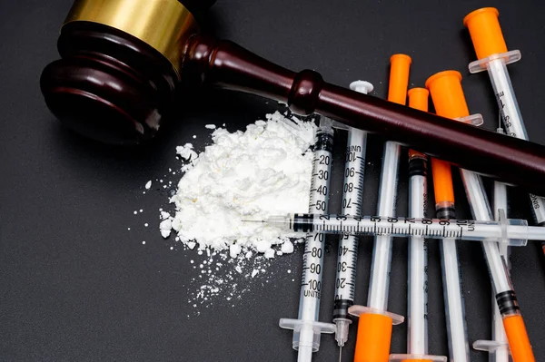 stock image Drug crime concept with white powder and disposable syringe on black background