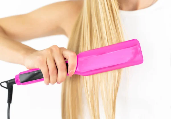 European Blonde White Background Straightens Her Hair Pink Curling Iron — Stock Photo, Image