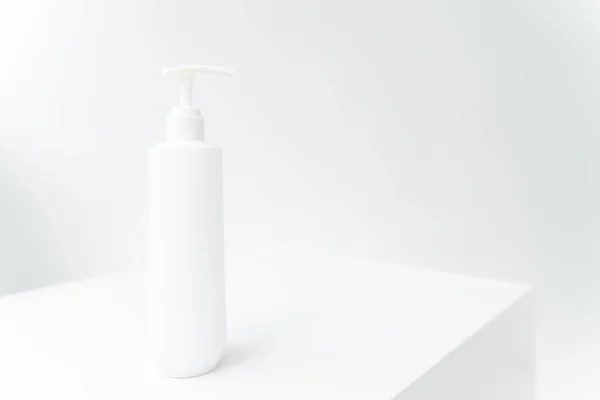stock image a white bottle with a dispenser on a white isolated background. Cometology, medicine