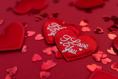 Red fabric hearts for Valentine's Day with white lettering I love you