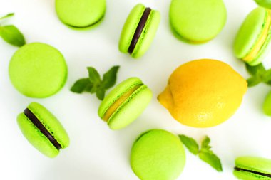 Green pasta with chocolate filling. Top view, layout with lemon and mint, confectioner