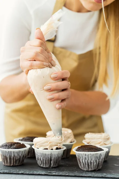 Successful Woman Pastry Chef Squeezes Cream Onto the Cake Using