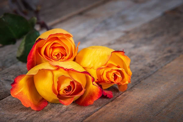 Three Beautiful Fresh Yellow Orange Roses Wooden Table Copy Space — Stock Photo, Image