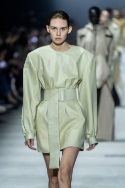 MILAN, ITALY - FEBRUARY 24: A model walks the runway at the Tods fashion show during the Milan Fashion Week Womenswear Fall/Winter 2023/2024 on February 24, 2023 in Milan, Italy. clipart