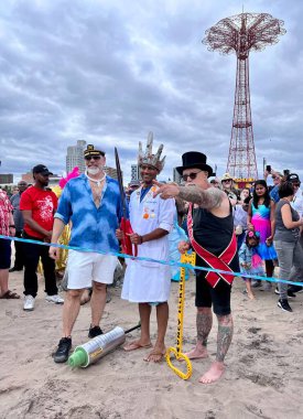 NEW YORK - JUNE 18, 2022: Dr. Dave A. Chokshi (C), Dick Zigun (R) at the ceremony of opening summer season during the 40th Annual Mermaid Parade at Coney Island, the largest parade in the nation and a celebration of ancient mythology on June 18, 2022