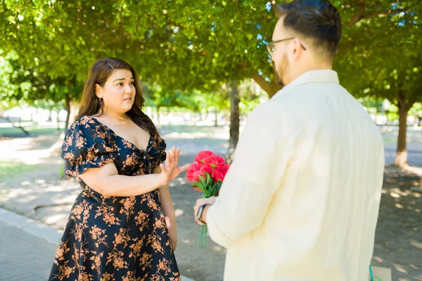 Upset Hispanic Woman Looking Annoyed While Rejecting Flowers Present Her — Stock Photo, Image