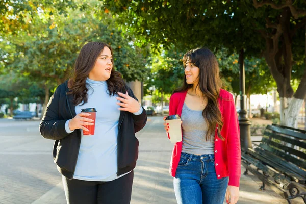 Attractive Latin Women Girlfriends Walking Park Drinking Coffee Talking — Stok fotoğraf