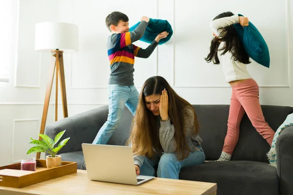 Sad Stressed Mother Her Children Playing While Suffering Headache Working — Stock fotografie