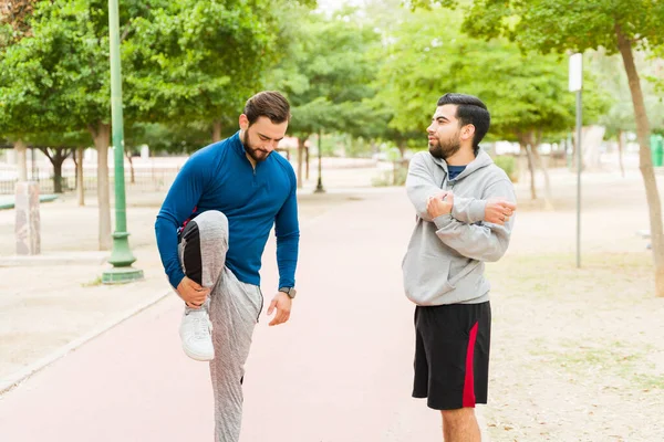 Attractive Young Men Stretching Doing Warm Exercises Park While Getting — Stock Photo, Image
