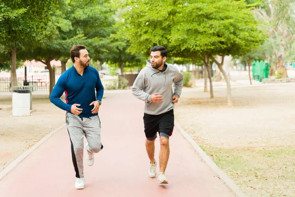 Attractive Active Young Men Jogging Running Together While Exercising Outdoors — Stock Photo, Image