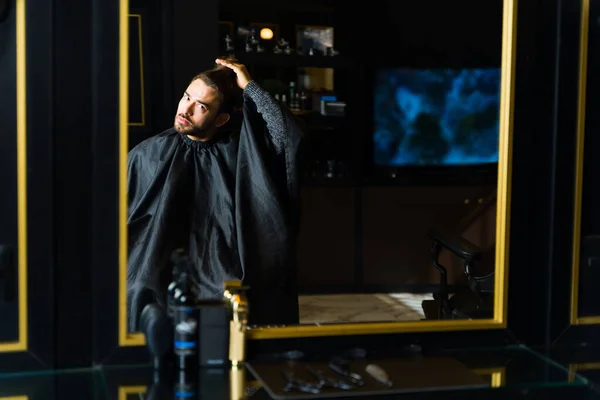Handsome Man Looking Mirror While Sitting Barber Shop Checking His — Stock fotografie