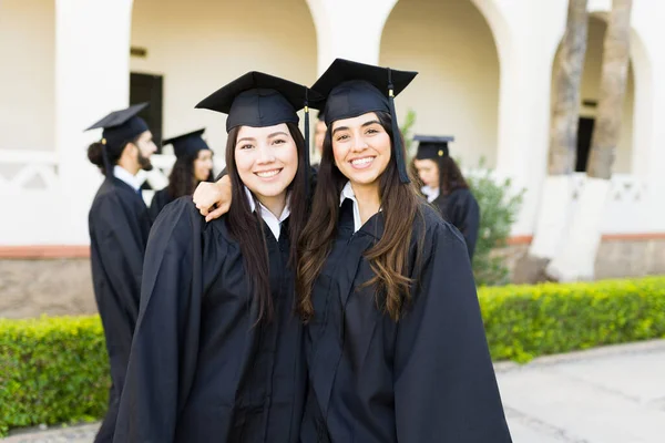 Happy Women Best Friends Hugging Smiling Wearing Graduation Gown Cap — Fotografia de Stock