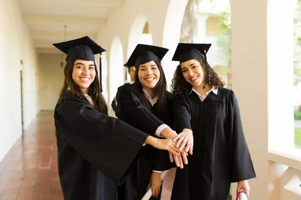 Women Best Friends Smiling Wearing Graduation Gowns Doing High Five — Fotografia de Stock