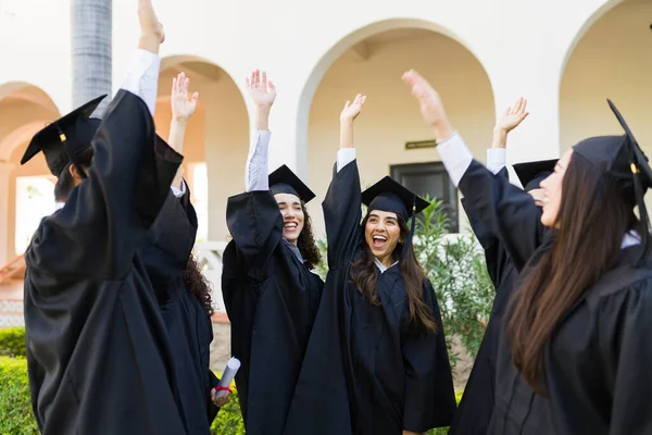 Happy Friends Graduation Gowns Looking Excited While Celebrating Graduating University — Fotografia de Stock
