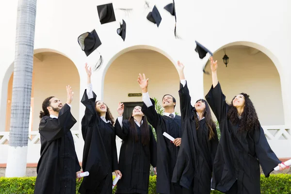 Young Women Men Throwing Graduation Caps Air Celebrating University Graduation — Fotografia de Stock
