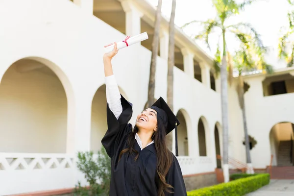 Beautiful Hispanic Woman Graduation Gown Looking Excited While Holding Her — Fotografia de Stock