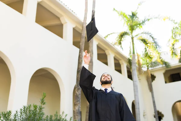 Hispanic Young Man Graduate Throwing His Graduation Cap Feeling Excited — Fotografia de Stock