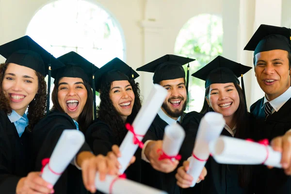 Excited Group Graduates Showing University Diplomas Laughing Graduation Ceremony — Fotografia de Stock