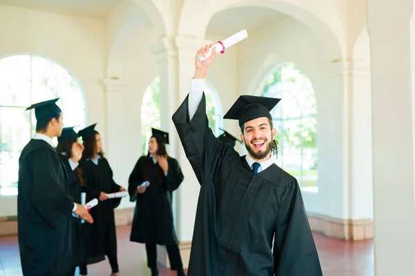 Excited Latin Man Graduate Raising His Diploma Air Celebrating Feeling — Fotografia de Stock